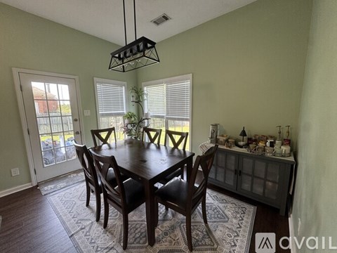 A dining room with a table set for six.