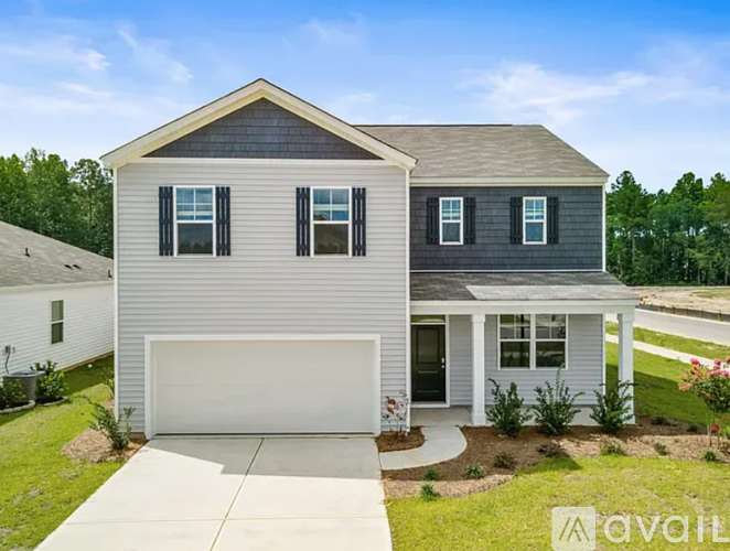 A two-story house with a garage is for sale.