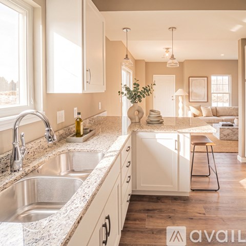 A kitchen with a marble countertop and a large window.