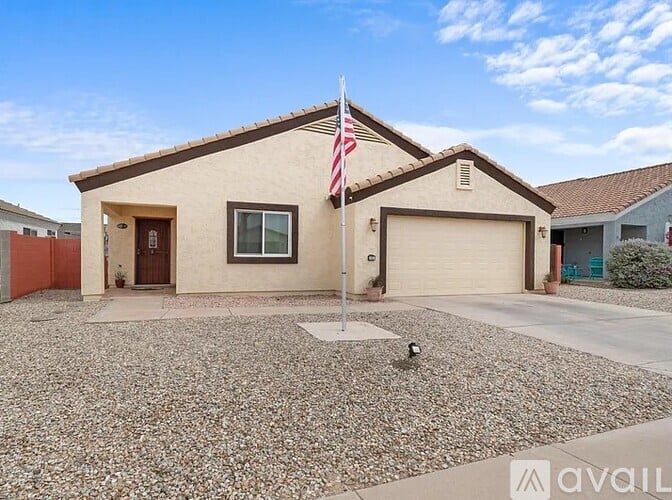 A house with a flag on the front lawn.