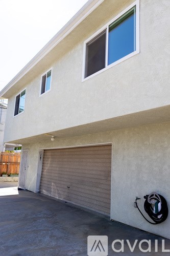 A house with a closed grey garage door.