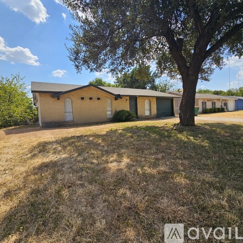 A house with a tree in front of it.