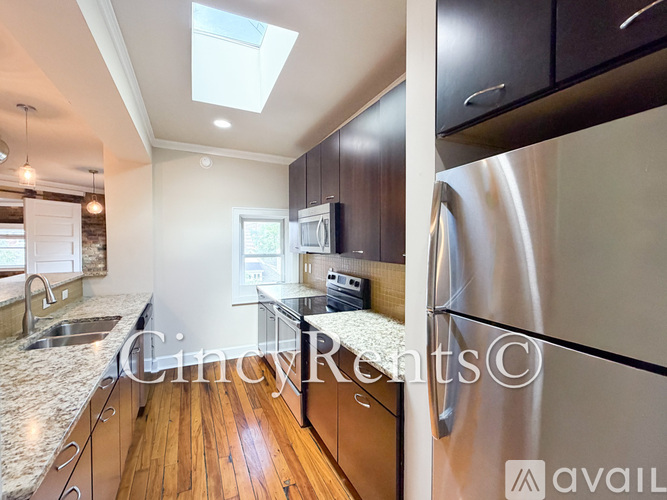 A modern kitchen with a washer and dryer built into the cabinetry.