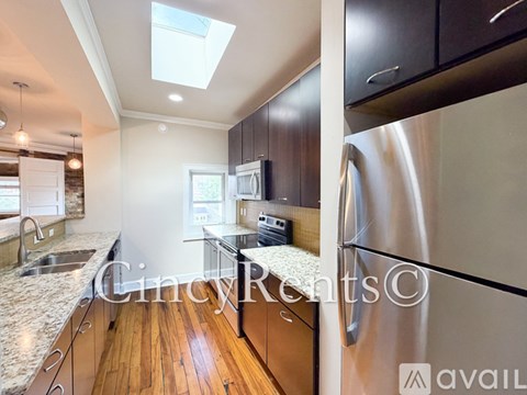A modern kitchen with a washer and dryer built into the cabinetry.