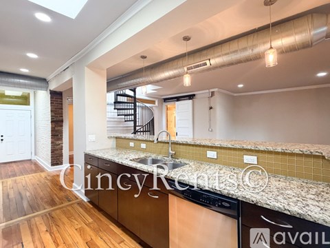 A kitchen with a sink and a counter top.