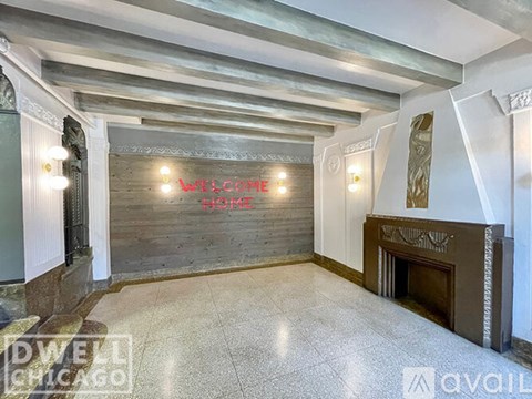 A welcoming home sign is displayed on a wooden wall in a spacious room.