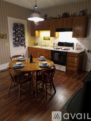 A kitchen with a table set for four.
