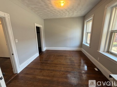 A room with wooden floors and white walls.