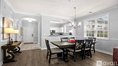 A dining room with a table set for four.