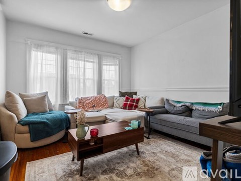 A living room with a couch, chair, and coffee table.