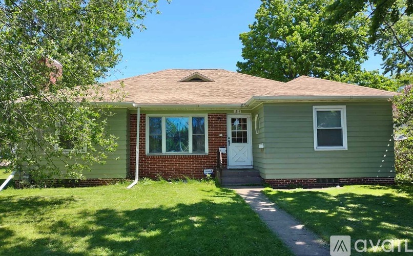 A house with a red brick wall and a white door.