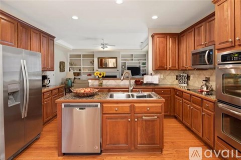 A kitchen with wooden cabinets and stainless steel appliances.