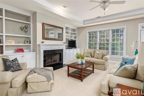 A living room with a fireplace, two couches, and a coffee table.