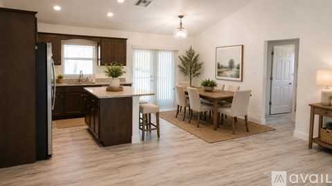 A kitchen with brown cabinets and a dining table with chairs.