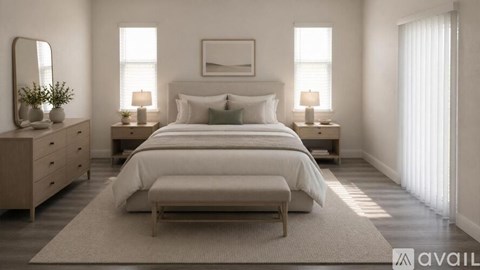 A bedroom with a large bed, a dresser, and a mirror.