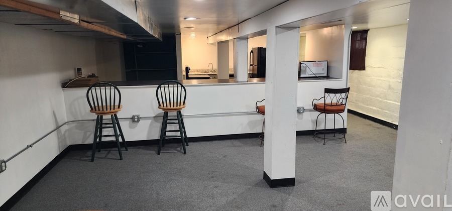 A kitchen with two chairs and a counter.
