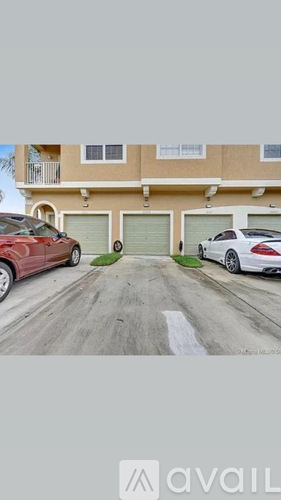 Two cars parked in front of a building with the word "available" written on the bottom.