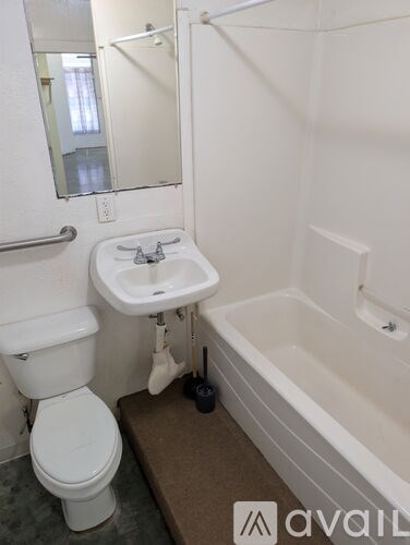 A bathroom with a toilet, sink, and bathtub.