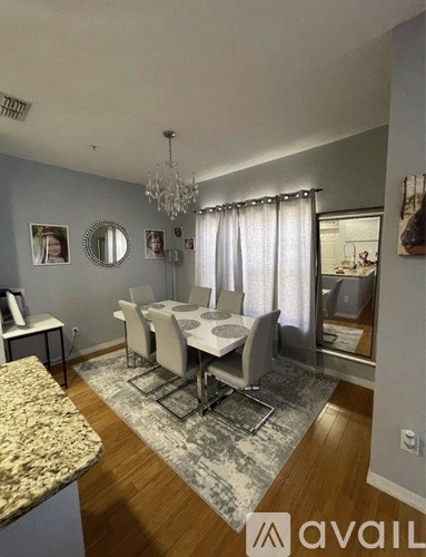 A dining room with a table set for four.