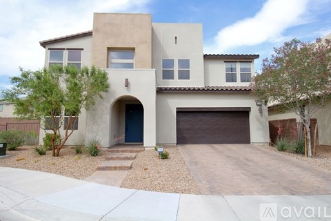 A modern house with a garage door and a driveway.