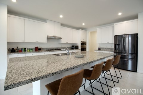 A kitchen with granite countertops and modern appliances.