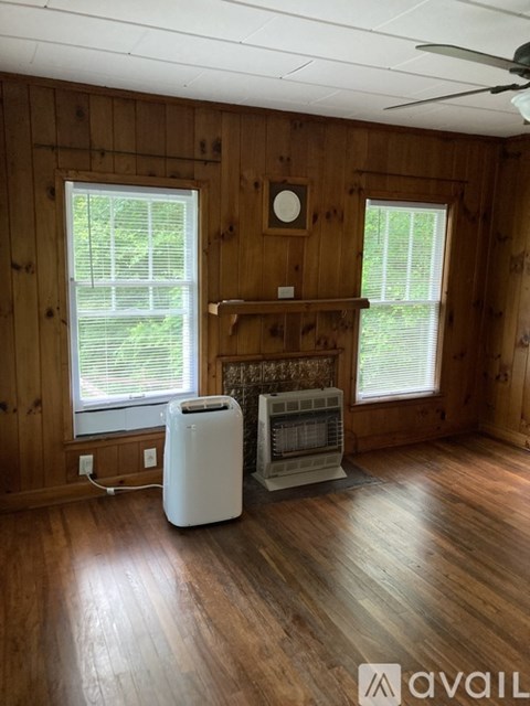 A room with wooden walls and a white air purifier.