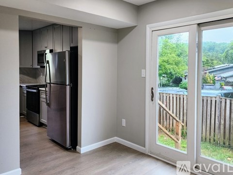 A kitchen with a refrigerator and a microwave.