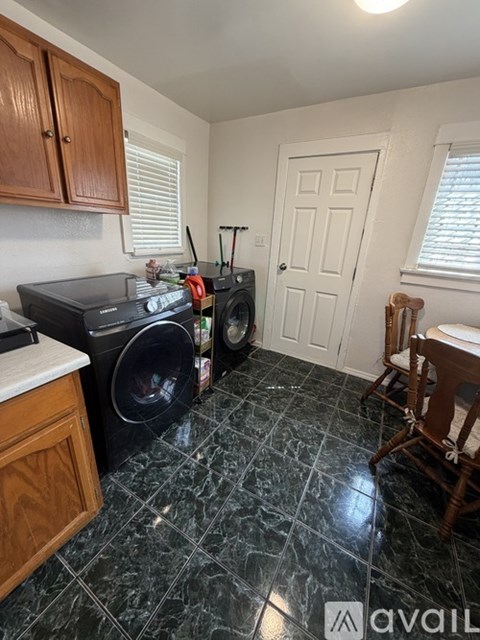 A kitchen with a black stove top oven and a black dishwasher.