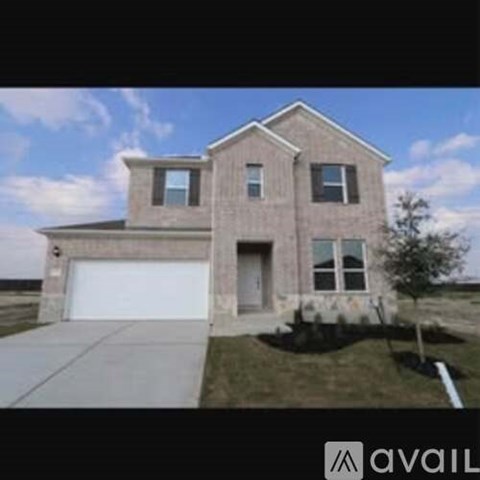 A two-story house with a garage is available for sale.