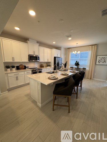 A modern kitchen with a dining table set for four.