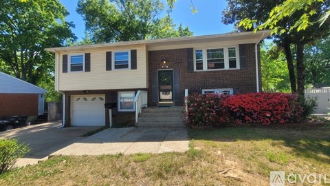 A house with a garage and a driveway is for sale.