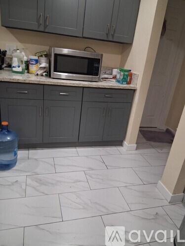 A kitchen with a microwave on the counter.