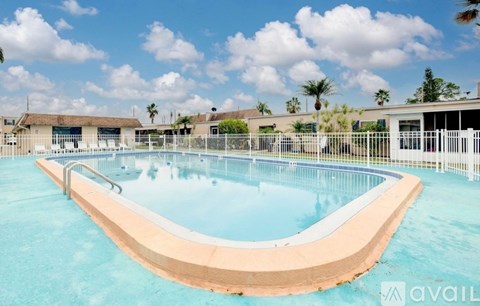 A large outdoor swimming pool with a curved wooden deck.