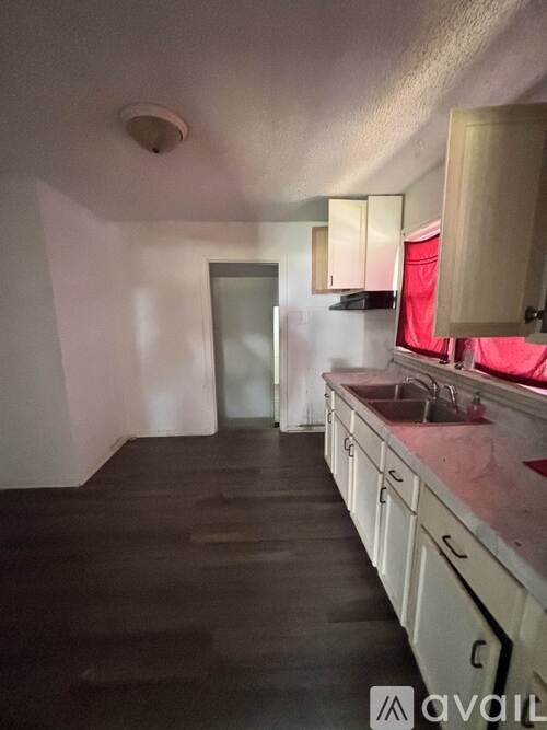 A kitchen with wooden cabinets and a sink.