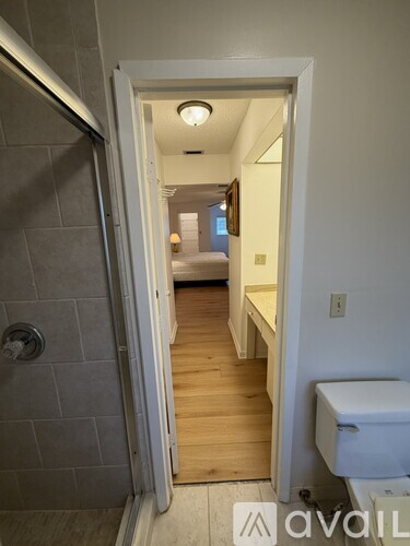 A bathroom with a toilet and a shower.