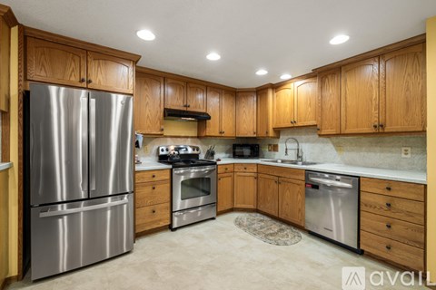 A kitchen with wooden cabinets and stainless steel appliances.