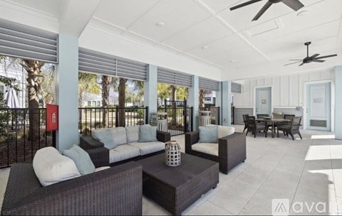 A spacious outdoor living area with a sofa set, coffee table, and a dining table.