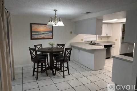A dining room with a table set for four.