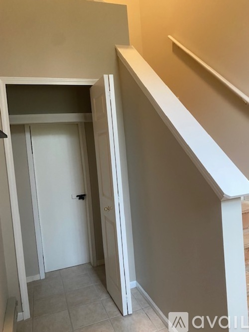 A hallway with a doorway leading to another room.
