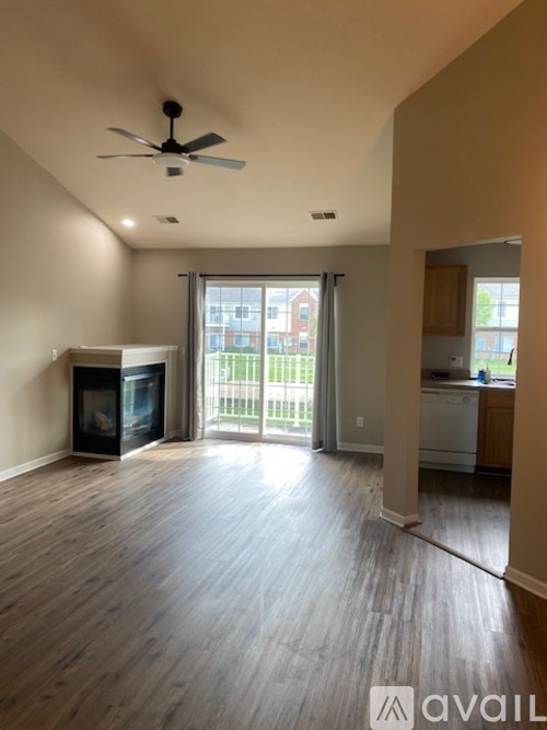 A spacious living room with a television and a fireplace.