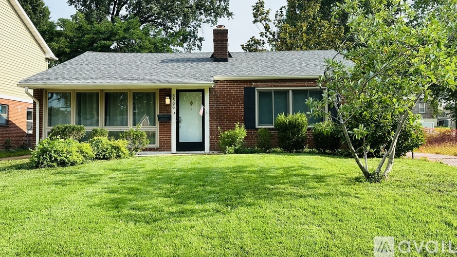 A house with a green lawn in front.
