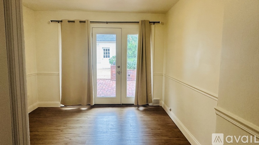 A room with a sliding door leading to a balcony.