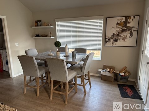A dining room with a table and chairs.