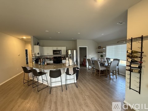 A modern kitchen with a dining table and chairs.