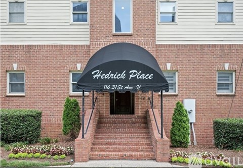 A brick building with a sign that says "Hedrick Place" above the entrance.