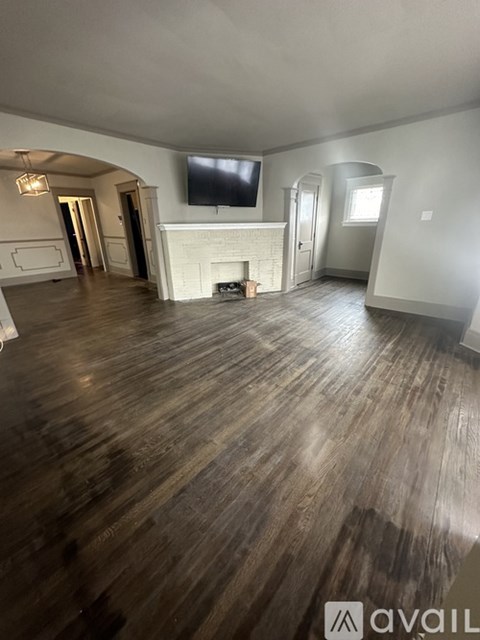 A living room with a fireplace and a television.