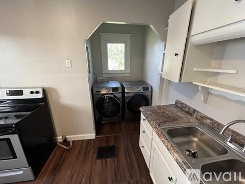 A kitchen with a black stove and a black dishwasher.