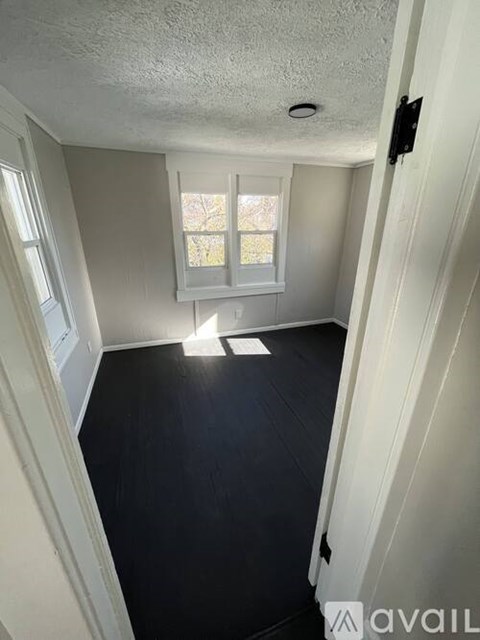 A room with a window and a door.