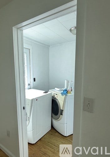 A small laundry room with a washer and dryer.
