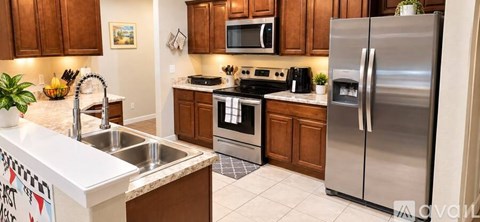 A kitchen with wooden cabinets and stainless steel appliances.